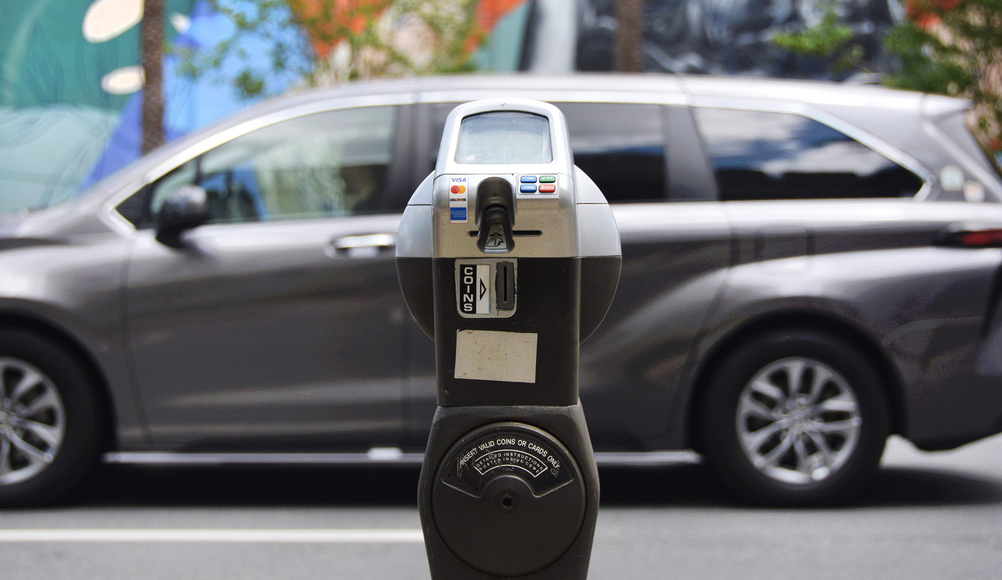 A car driving past a parking meter in Downtown Orlando